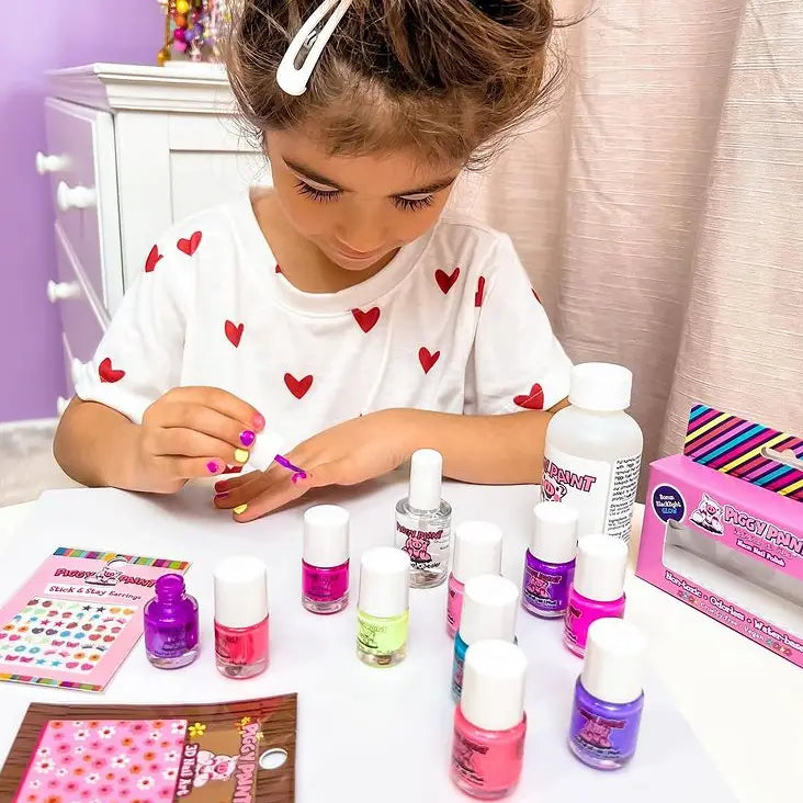 Child painting nails with Nail Polish Fairy Berry water-based, non-toxic, cruelty-free, and vegan nail polish set.