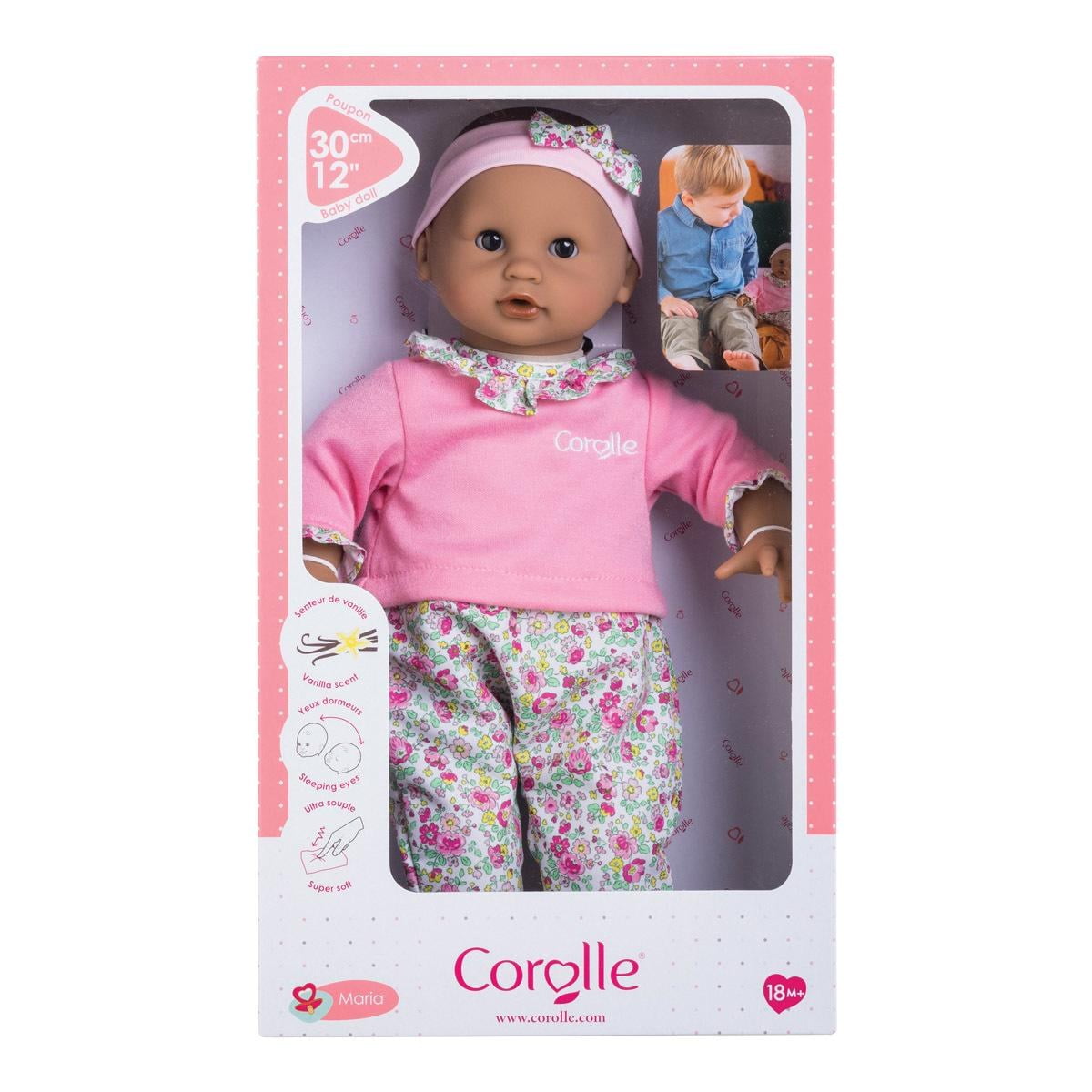 12-inch baby doll with brown eyes dressed in pink pajamas and floral pants in Corolle packaging for ages 18 months+