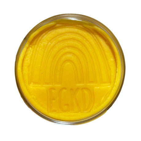 KidDough | Yellow in a container with a smooth, soft texture and embossed rainbow design on top.