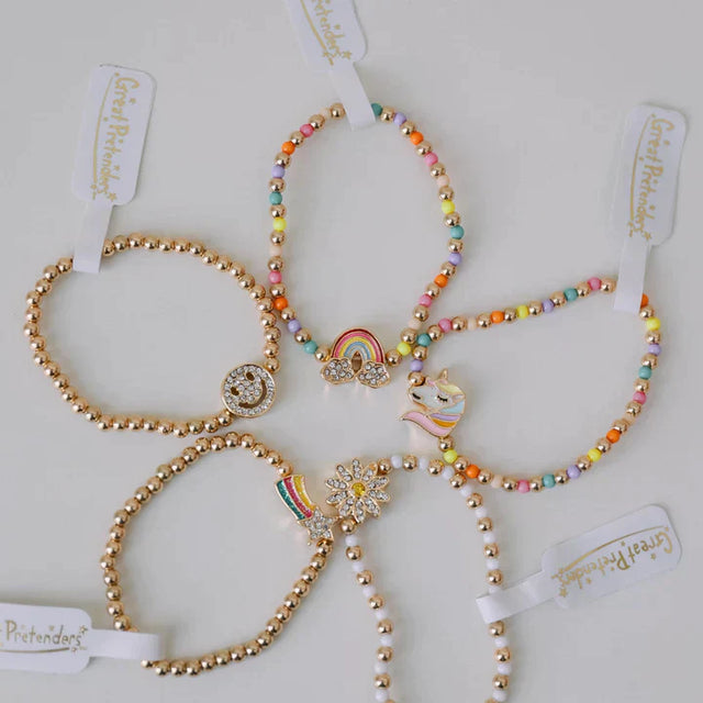 Taylor's Bestie Bracelet set with colorful beads and gold charms including rainbow, unicorn, and smiley face designs.