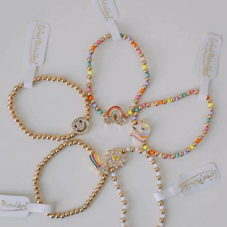 Taylor's Bestie Bracelet set with colorful beads and gold charms including rainbow, unicorn, and smiley face designs.