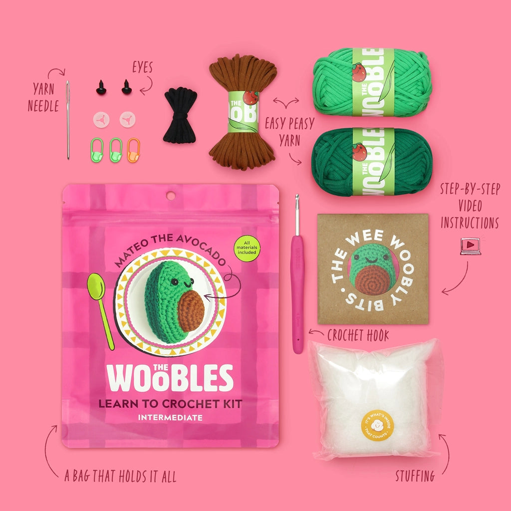 The Woobles Crochet Kit | Mateo the Avocado with yarn, crochet hook, stuffing, eyes, needle, and stitch markers.