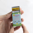 Kawaii Chick Mini Cross Stitch Matchbook kit showing colorful threads and packaging held in hand for beginners.