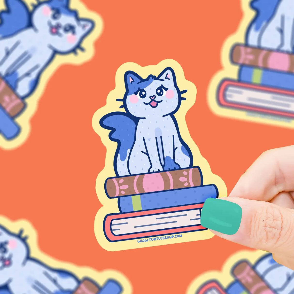 Cat on Stacked Books Sticker showing a cute blue cat sitting on colorful books, printed on durable vinyl for lasting use.