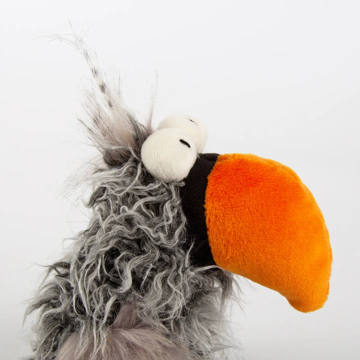 Bird Slow Flyer plush toy with soft curly gray fur and large bright orange beak, perfect for ages 3 and up.