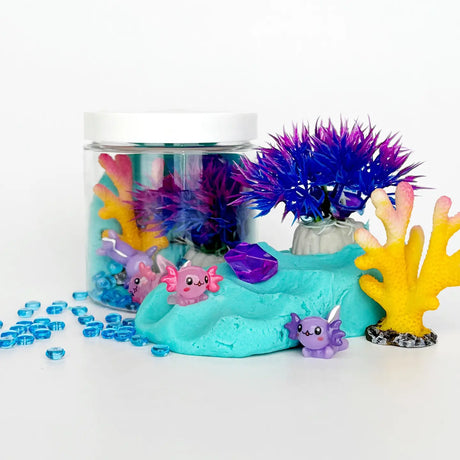 KidDough To Go Mini | Axolotl sensory play kit with blue KidDough, axolotl figures, colorful plants, and glow rocks.