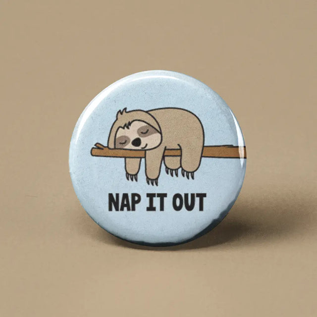 Button | Nap it Out Sloth featuring a sleeping sloth illustration with the words "NAP IT OUT" on a light blue background.