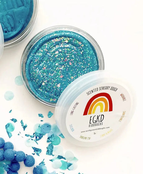 KidDough Glitter | Blue sensory dough in a clear container with colorful glitter accents, soft and pliable for kids’ play.