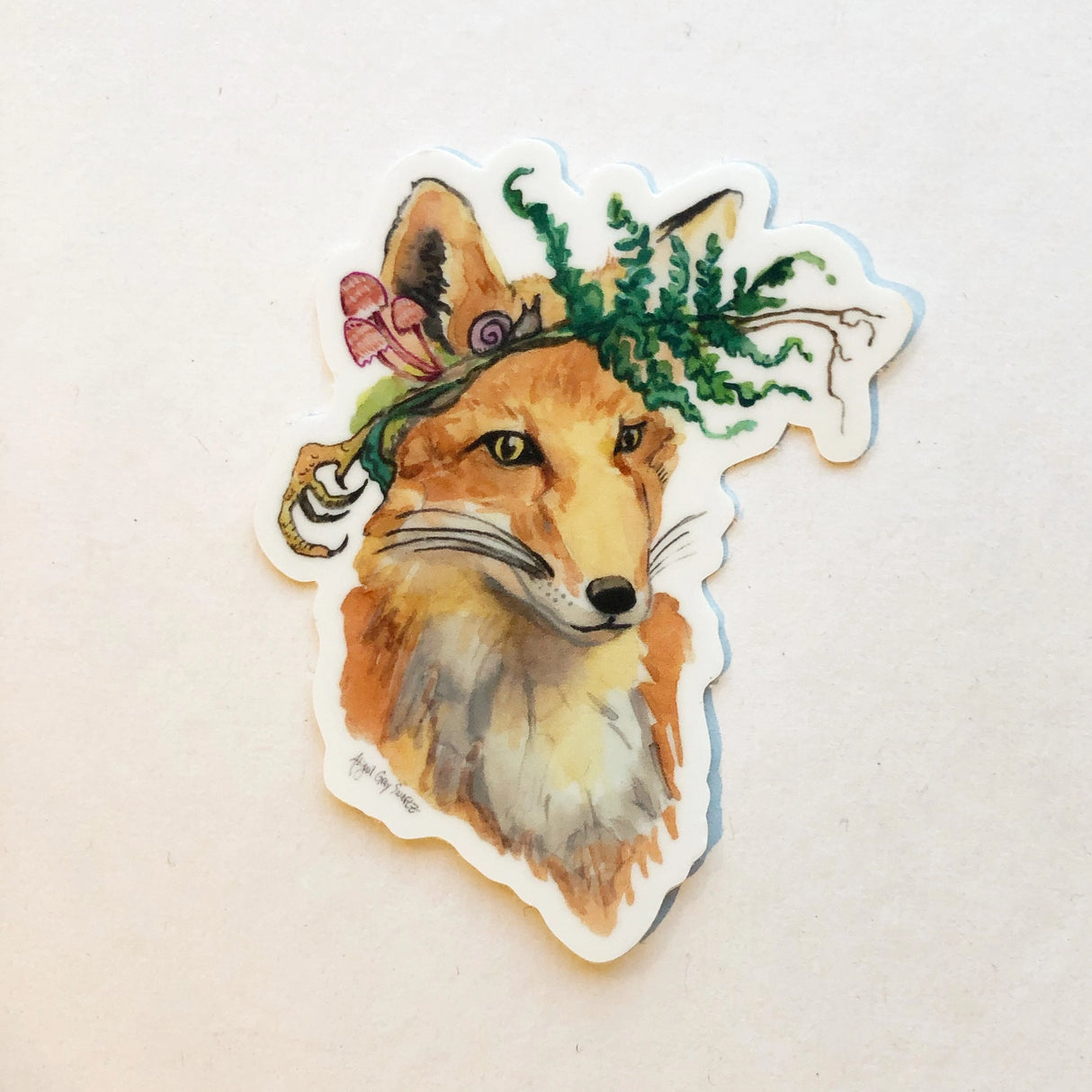 Foraging Fox Sticker showing a watercolor fox with a fern and mushrooms crown, handmade by Gray Day Studio.