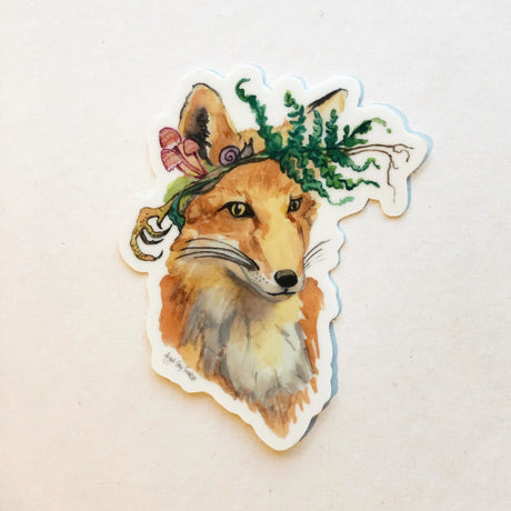 Foraging Fox Sticker showing a watercolor fox with a fern and mushrooms crown, handmade by Gray Day Studio.