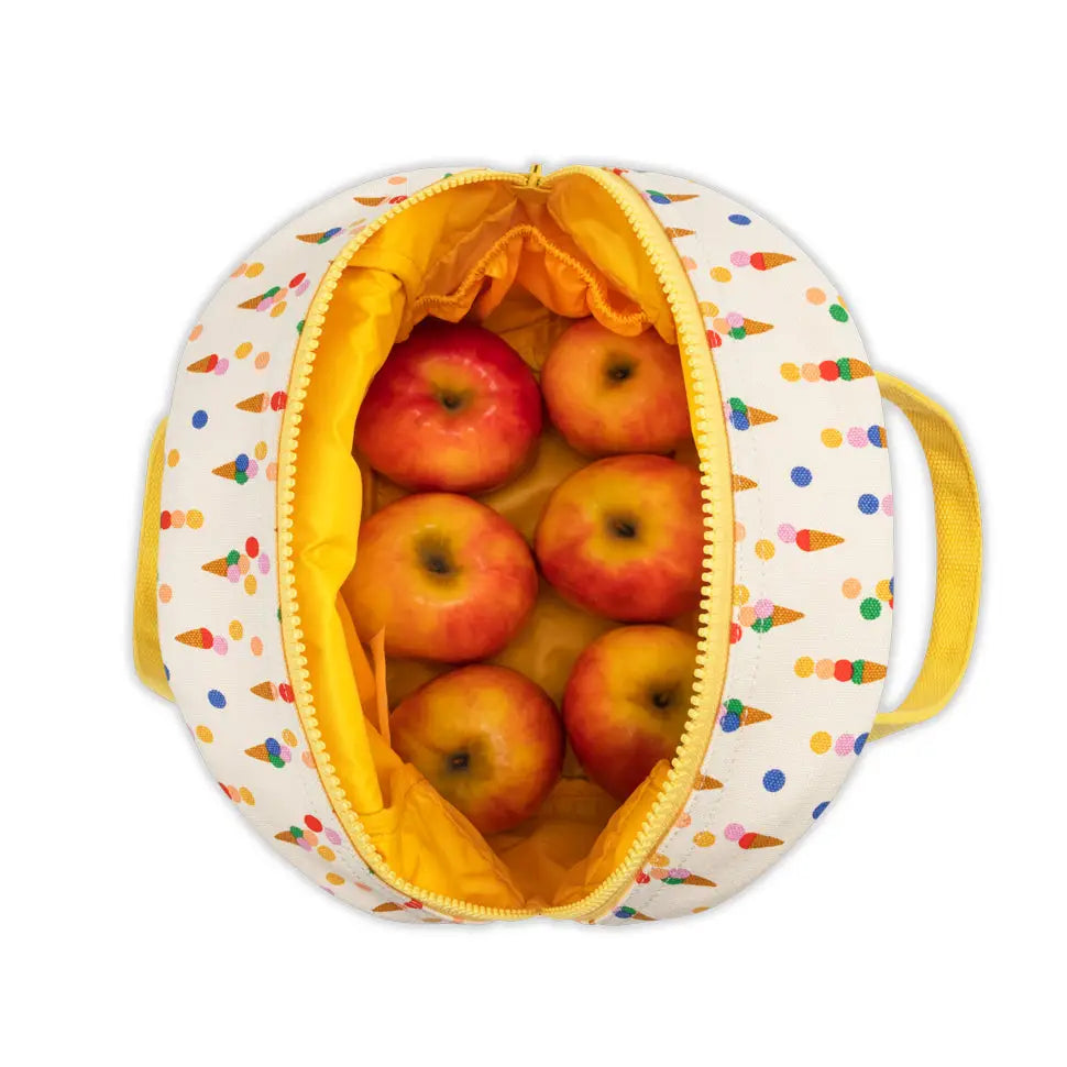 Top view of zipper lunch bag with colorful cone pattern holding six red apples inside