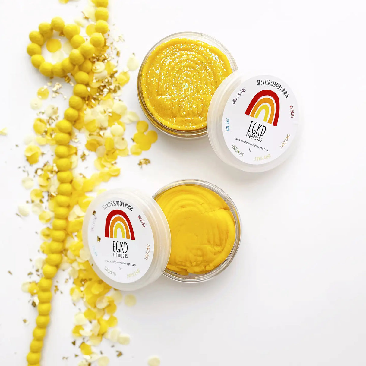 KidDough Glitter | Yellow sensory dough with glitter in containers, soft and pliable for creative play.