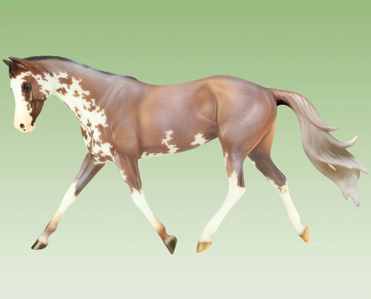 Full Moon Rising model horse in mid-stride, showcasing detailed paint and realistic Thoroughbred features.