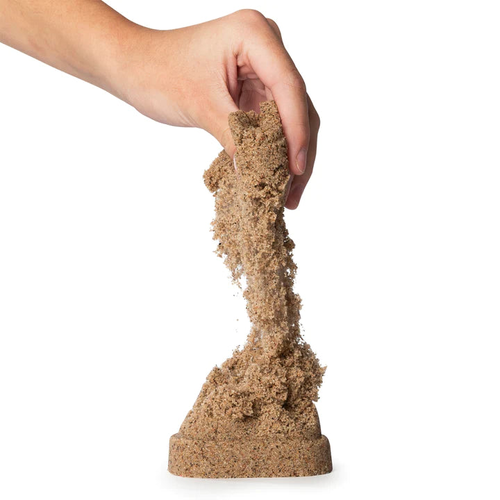 Hand holding and letting flow Kinetic Sand | 3lb Beach Sand with natural large grains on white background