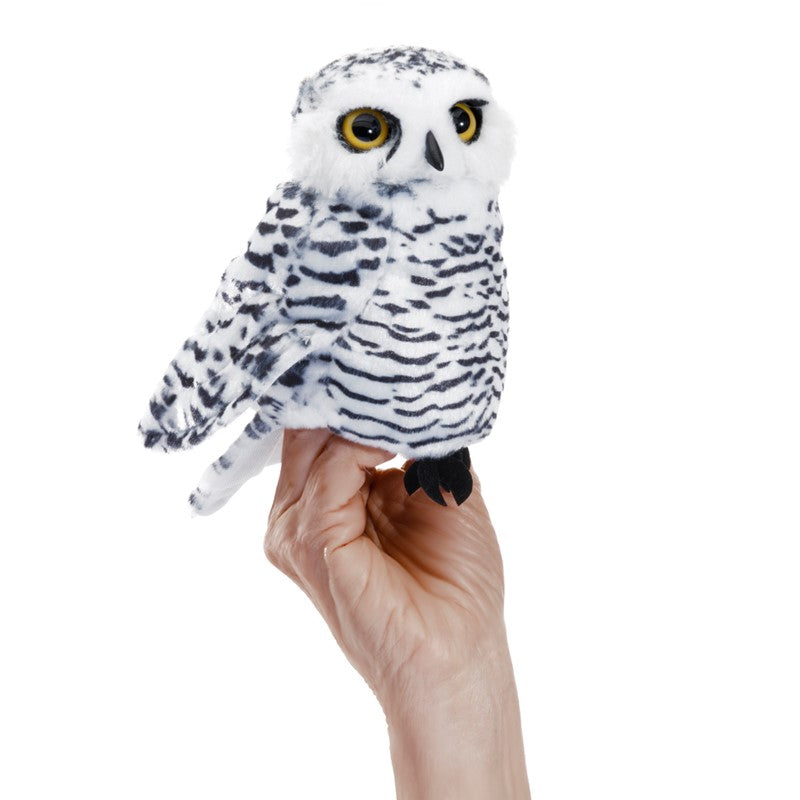 Hand holding Snowy Owl Small puppet with soft boa fabric and expressive eyes on white background.