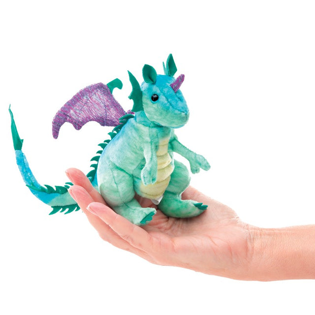 Hand holding a colorful Dragon Finger Puppet with teal body and purple wings, perfect for imaginative play.