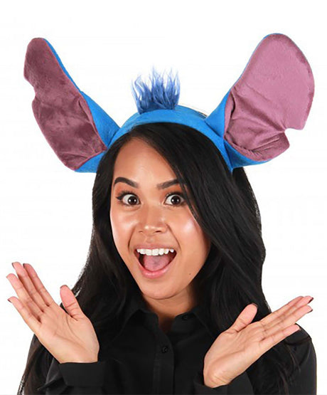 Lilo & Stitch Stitch Headband worn by smiling woman with large blue and purple plush ears and tuft of hair.