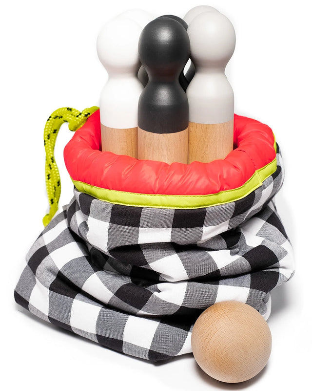 Bowling set with 6 beech wood pins and balls in a black and white checkered bag with red trim.