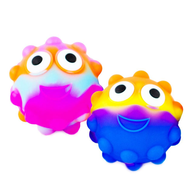 Two colorful Tutti Fruiti Eye Ball toys with popping eyes and smiling faces in bright shades of pink, blue, and orange.
