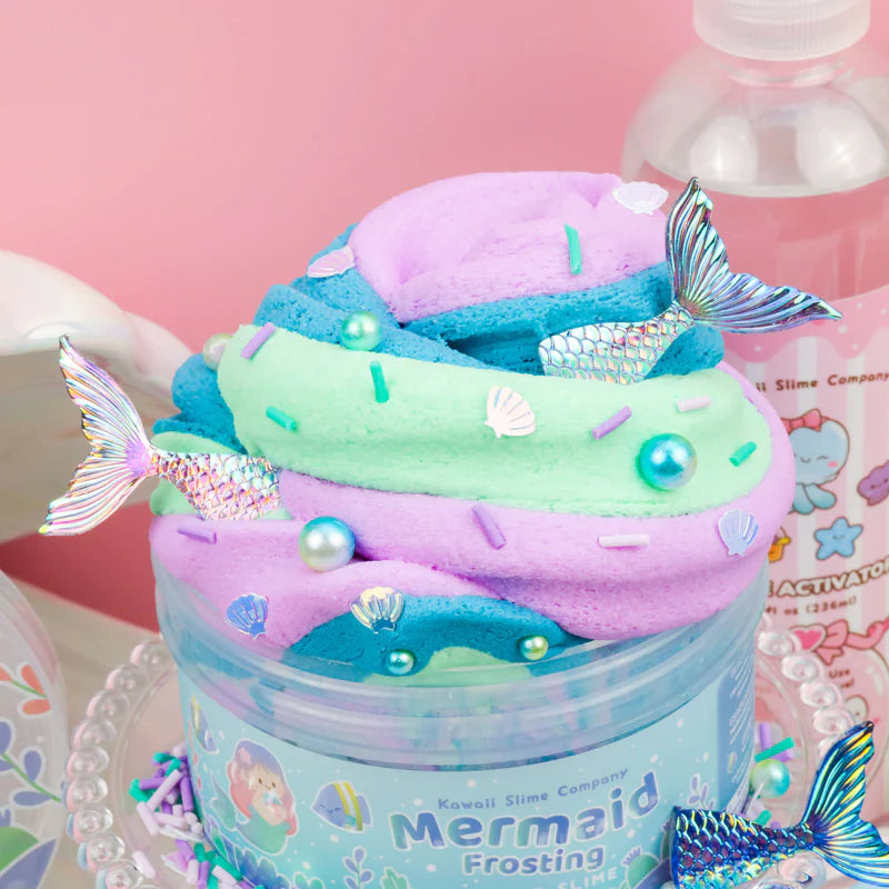 Mermaid Frosting Butter Slime with swirls of purple, blue, green, and mermaid tail decorations in a clear jar.