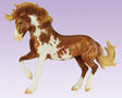 Mojave Mustang model horse with flowing mane, rich overo pinto coat, poised stance, and detailed sculpting against a purple background.