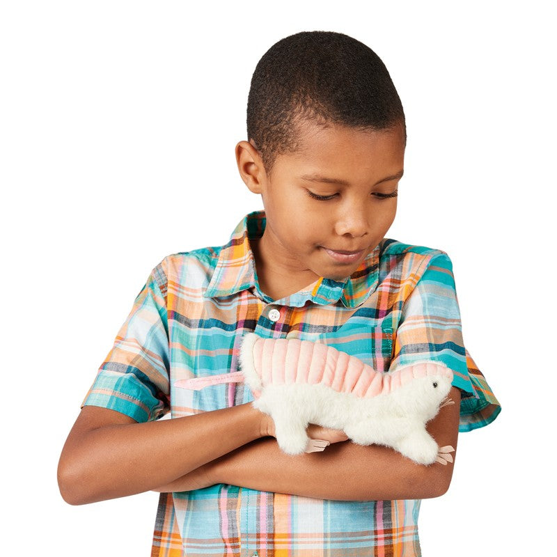 Boy holding a Pink Fairy Armadillo puppet with a soft ivory body and pink velour shell in his arms.