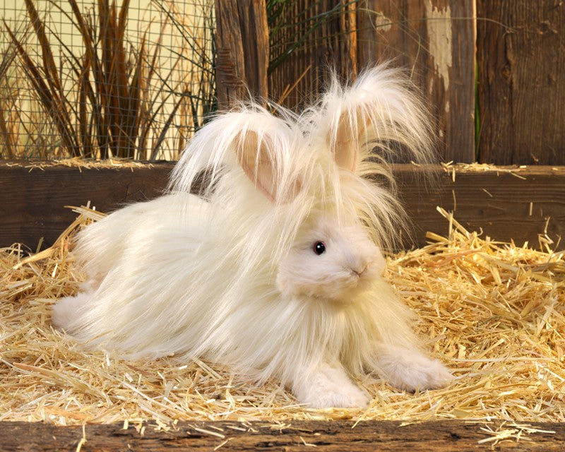 Angora Rabbit Puppet with fluffy soft long pile plush and signature rabbit ears resting on straw in rustic setting.