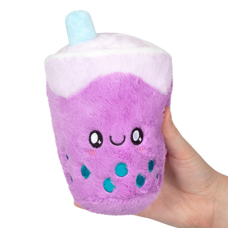 Hand holding a plush purple bubble tea snack with a smiling face, called Bubble Tea Snackers.
