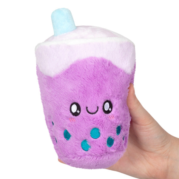 Hand holding a plush purple bubble tea snack with a smiling face, called Bubble Tea Snackers.