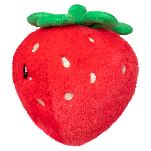 Soft and cuddly Strawberry Snackers plush toy shaped like a bright red strawberry with green leaves on top.