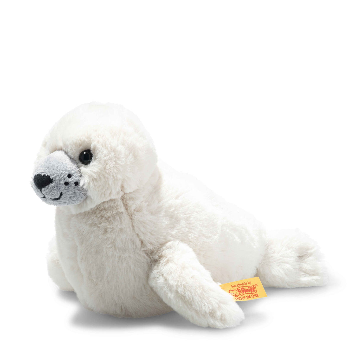 Seal Pup Aro plush toy, soft white baby seal with stitched whiskers and safety eyes, made by Steiff, 8 inches tall.