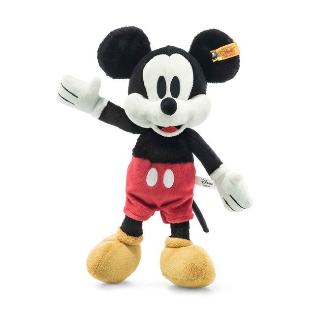 Disney's Mickey Mouse plush toy standing and waving with red shorts, yellow shoes, and trademark Steiff tag.