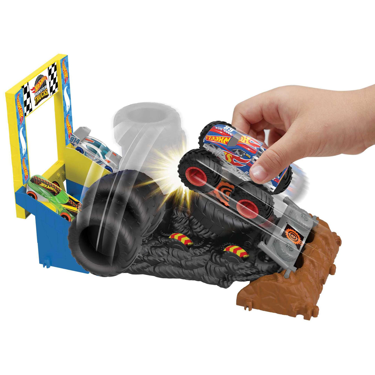 Hand playing with Hot Wheels Monster Trucks Arena Smashers Race Ace Smash Race Challenge with tires and obstacles.