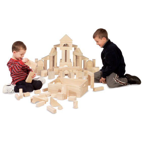 Two children playing and building a structure with the Wooden Blocks Set, featuring smooth natural hardwood blocks.