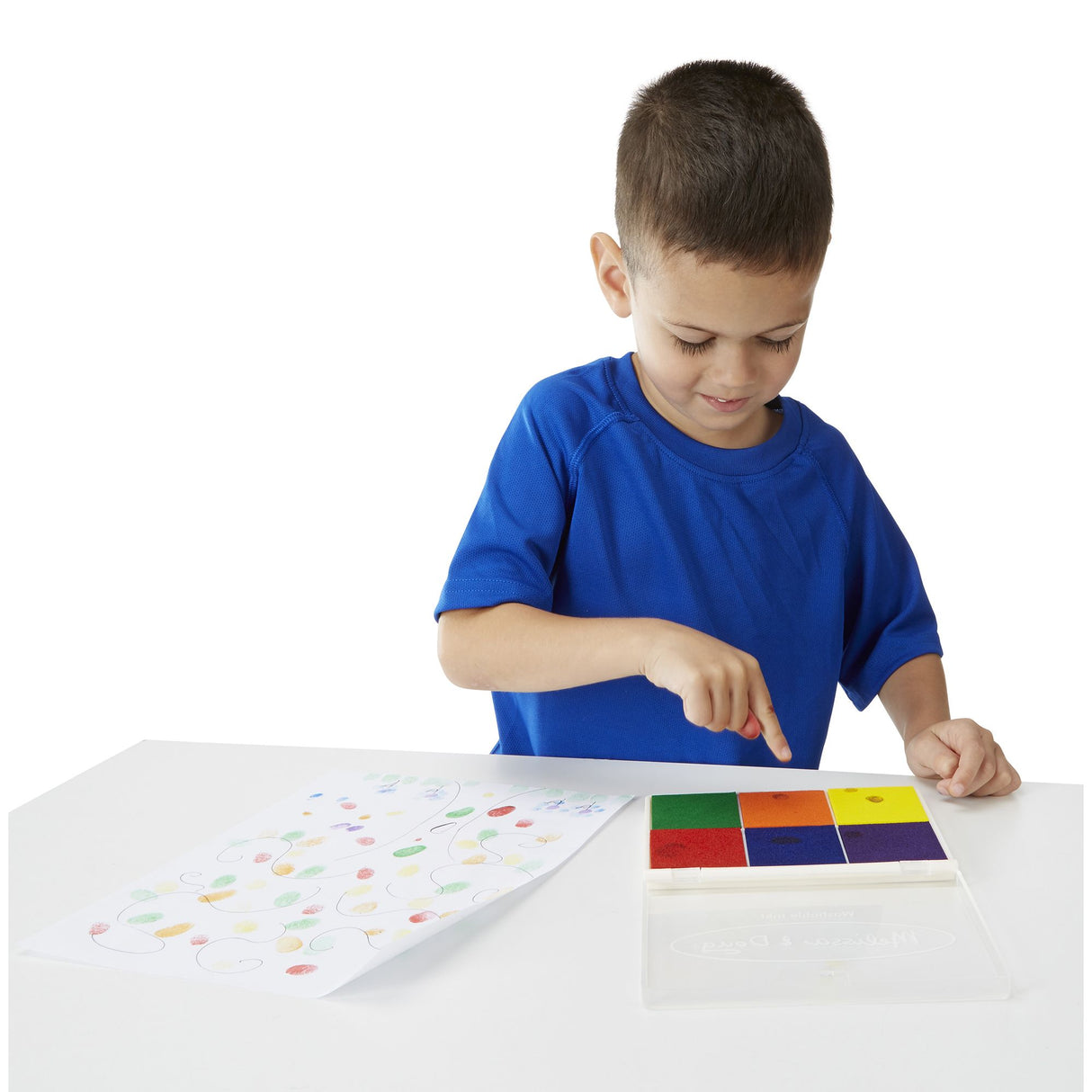 Young boy using the Stamp Rainbow Ink Pad with six bright washable colors for creative stamping fun.