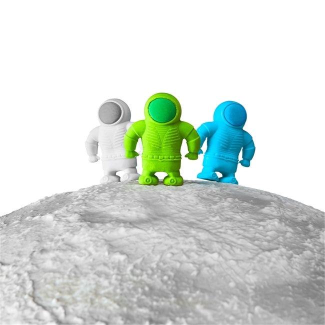 Astronaut Erasers set with blue, green, and white space-themed erasers standing on a textured surface.