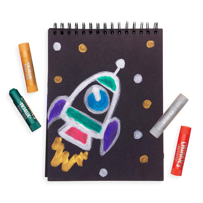 Chunkies Paint Sticks Metallic with colorful drawing of a rocket on black paper and five metallic paint sticks around it.