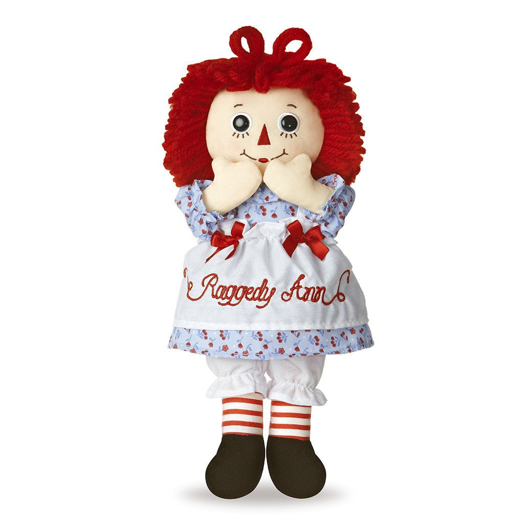 Classic Raggedy Ann doll with red yarn hair, candy-cane striped tights, and vintage-inspired dress, 12 inches tall.