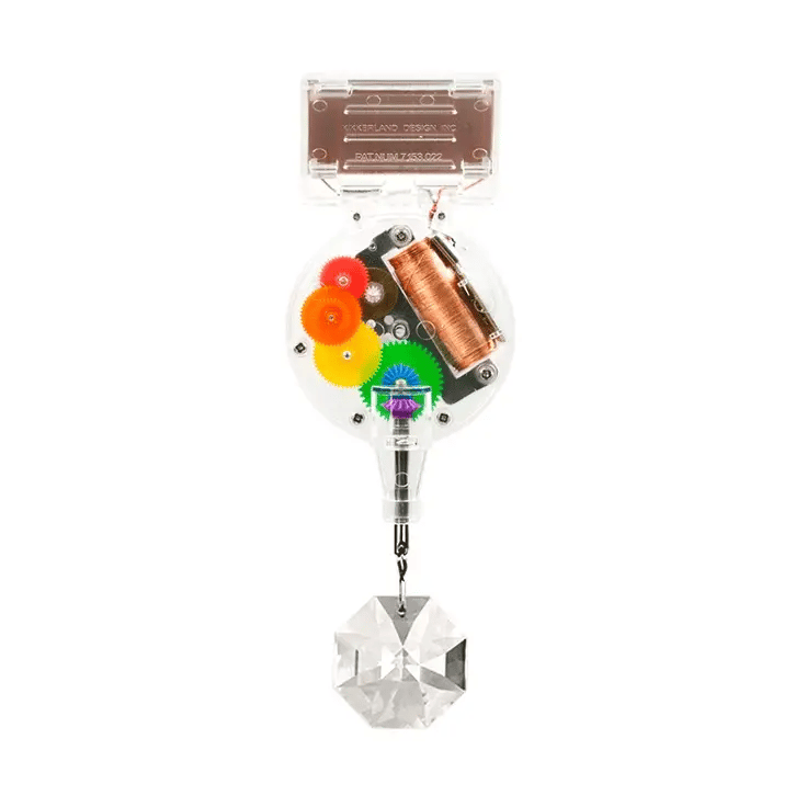 RainbowMaker solar-powered device with colorful gears and genuine crystal prism hanging below on white background.