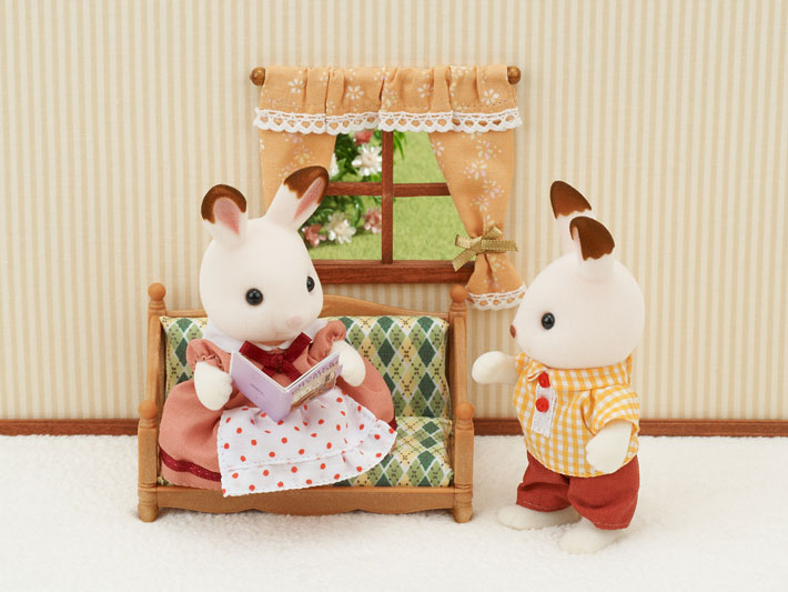 Comfy Living Room set with sofa, armchair, and window backdrop featuring two rabbit figures in cozy attire.