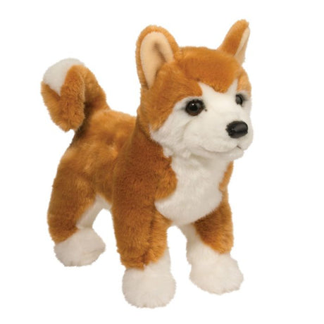 Shiba Inu Dunham plush toy standing upright with golden orange coat, curled tail, and black leatherette nose.