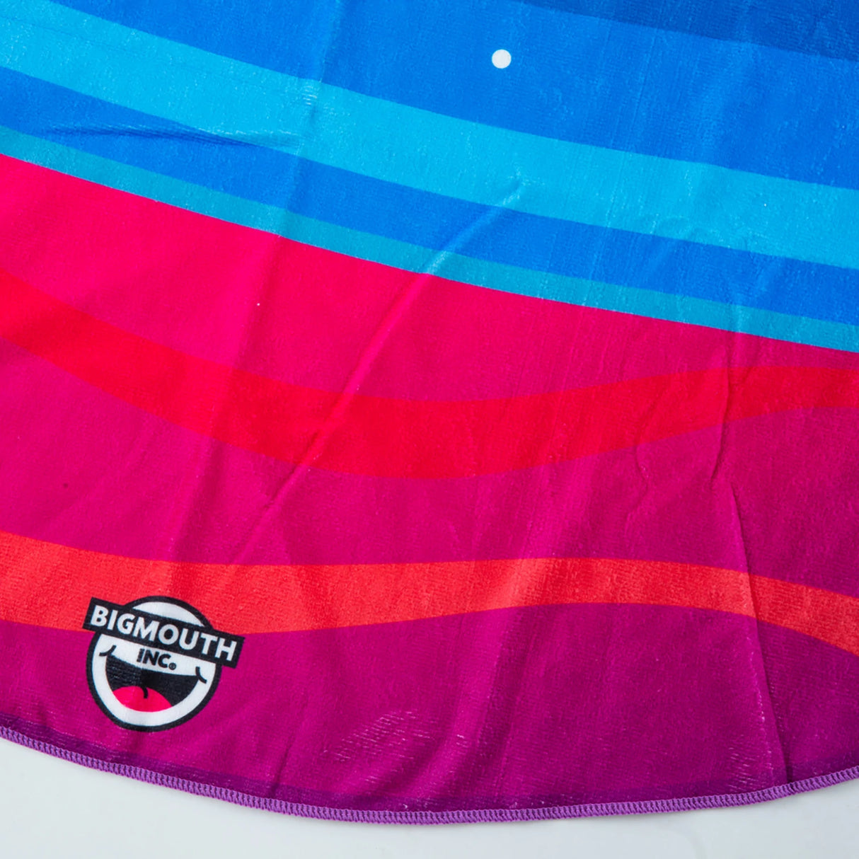 Close-up of colorful five-foot wide ultra-soft Beach Blanket | Planet with vibrant stripes and BigMouth Inc. logo.
