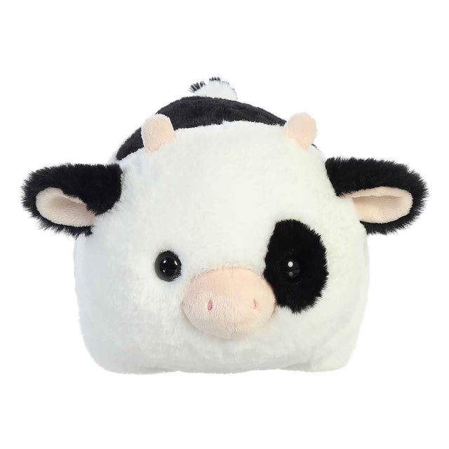 Spudster Cow Tutie plush with soft white and black body, folded ears, plush horns, and round cuddly shape.