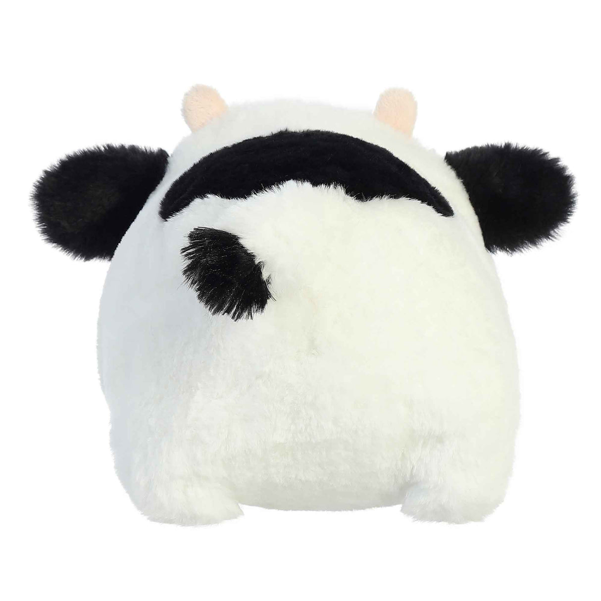Spudster Cow Tutie plush toy with soft white and black fur, folded ears, plush horns, and round cuddly shape.