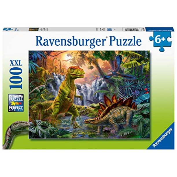 100pc Prehistoric Oasis Puzzle featuring vibrant dinosaurs in a lush prehistoric jungle scene for ages 6 and up.