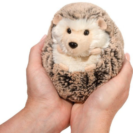 Hands holding a small, ultra-soft plush toy hedgehog named Hedgehog Spunky Small, perfect for kids ages 2 and up.