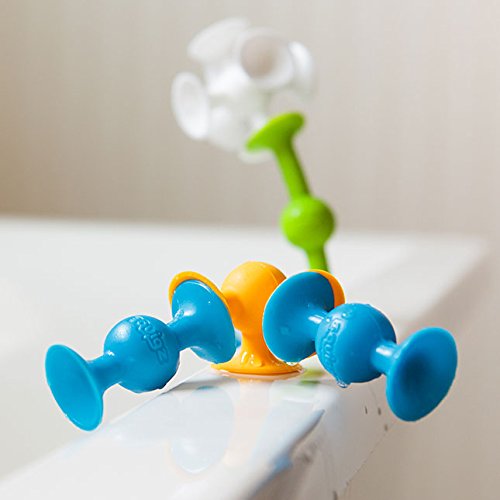 Squigz colorful suction toys connected on a white surface encouraging creativity and playful experimentation.