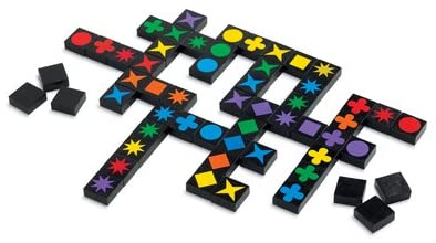 Qwirkle game setup showing colorful wooden tiles with shapes and colors matched in lines for strategic play.