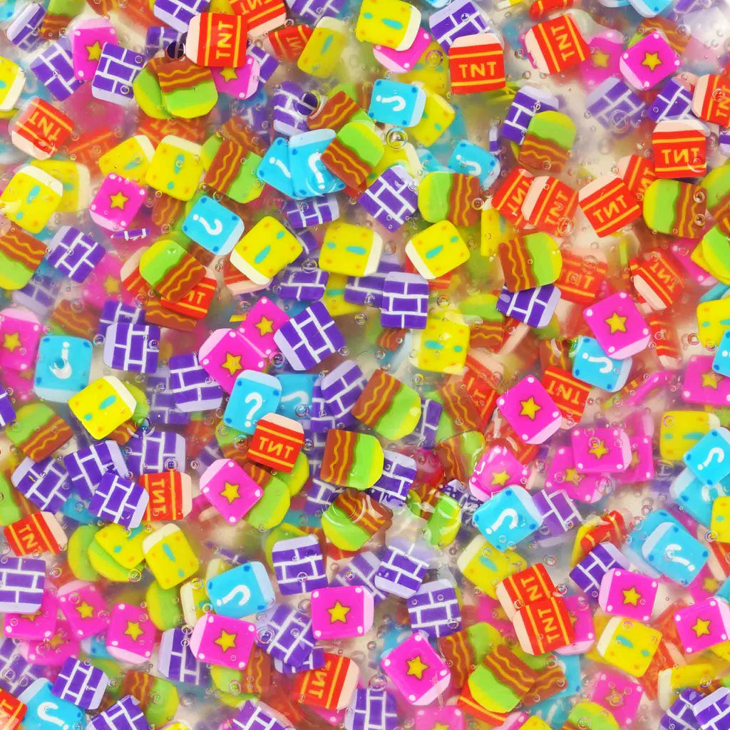 Colorful arcade-themed pieces embedded in clear putty for Hide Inside! Arcade Adventure Thinking Putty product.