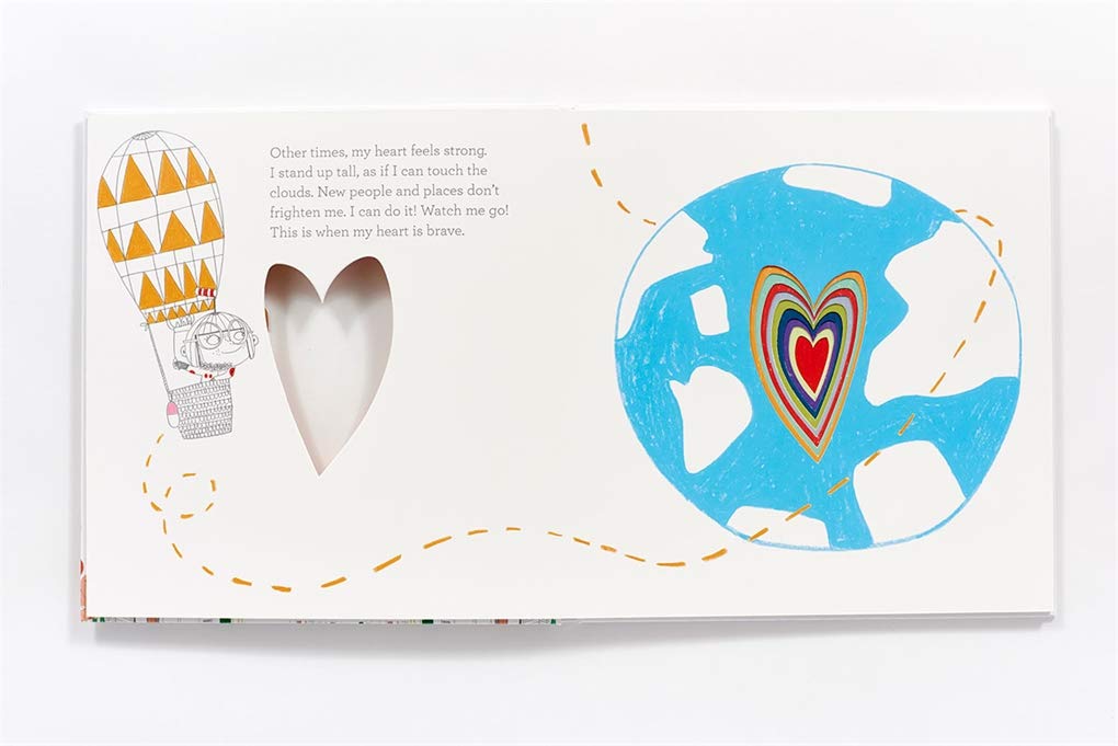 In My Heart picture book open to colorful heart and balloon illustrations with die-cut heart shape on page.